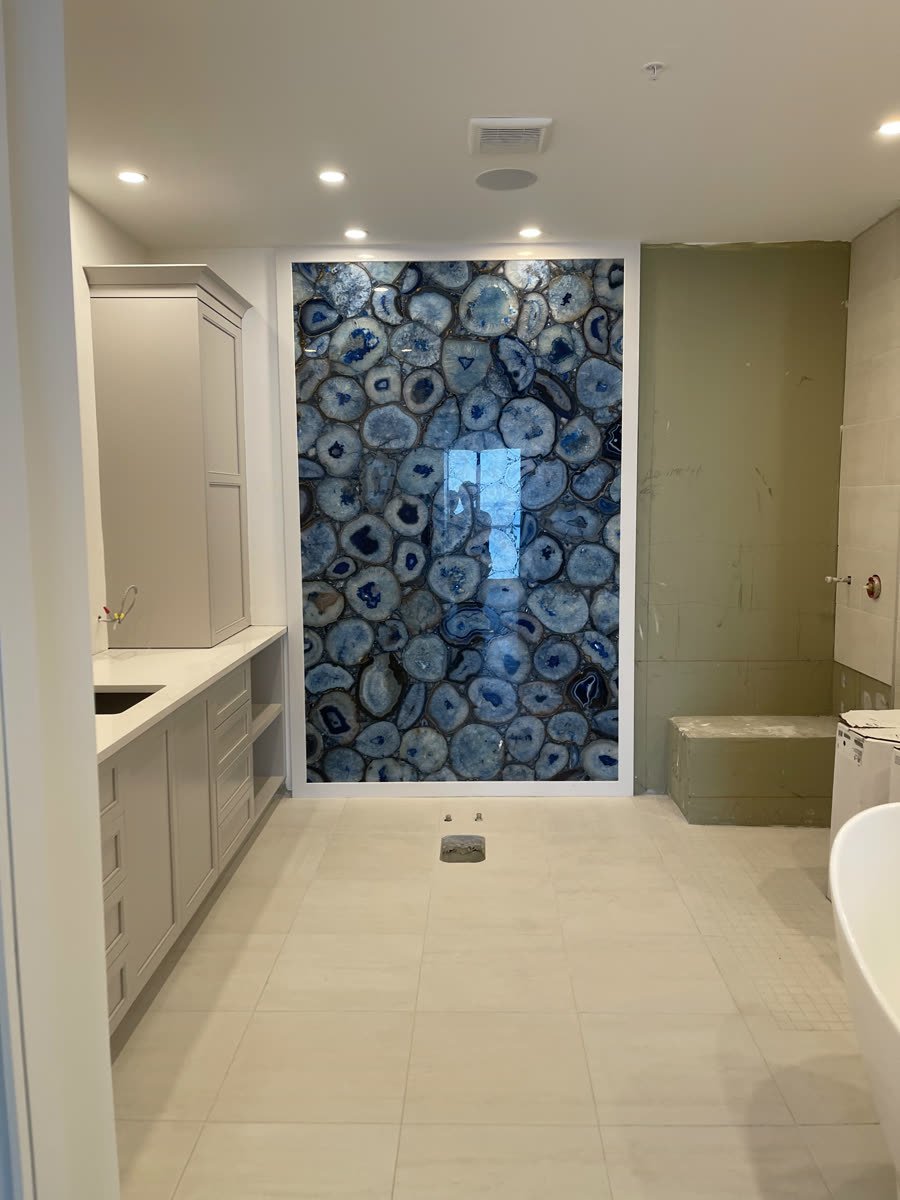 Master bath remodel with a blue agate stone wall