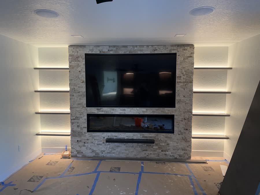 Stone installed and shelf lighting switched on for testing, floors still covered